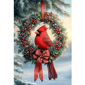 Cardinal bird on a wreath with berries and a red bow against a snowy background