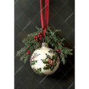 Decorative Christmas ornament with holly design on a dark background