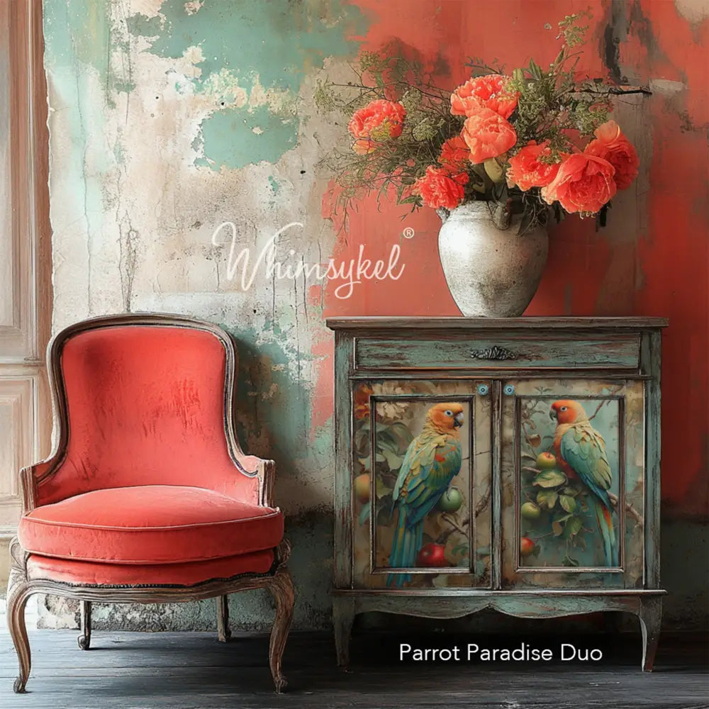 A vintage small buffet table next to a red sitting chair has a vase of bright coral flowers on it and features Whimsykel's Parrot Paradise Duo tissue paper on its 2 doors.