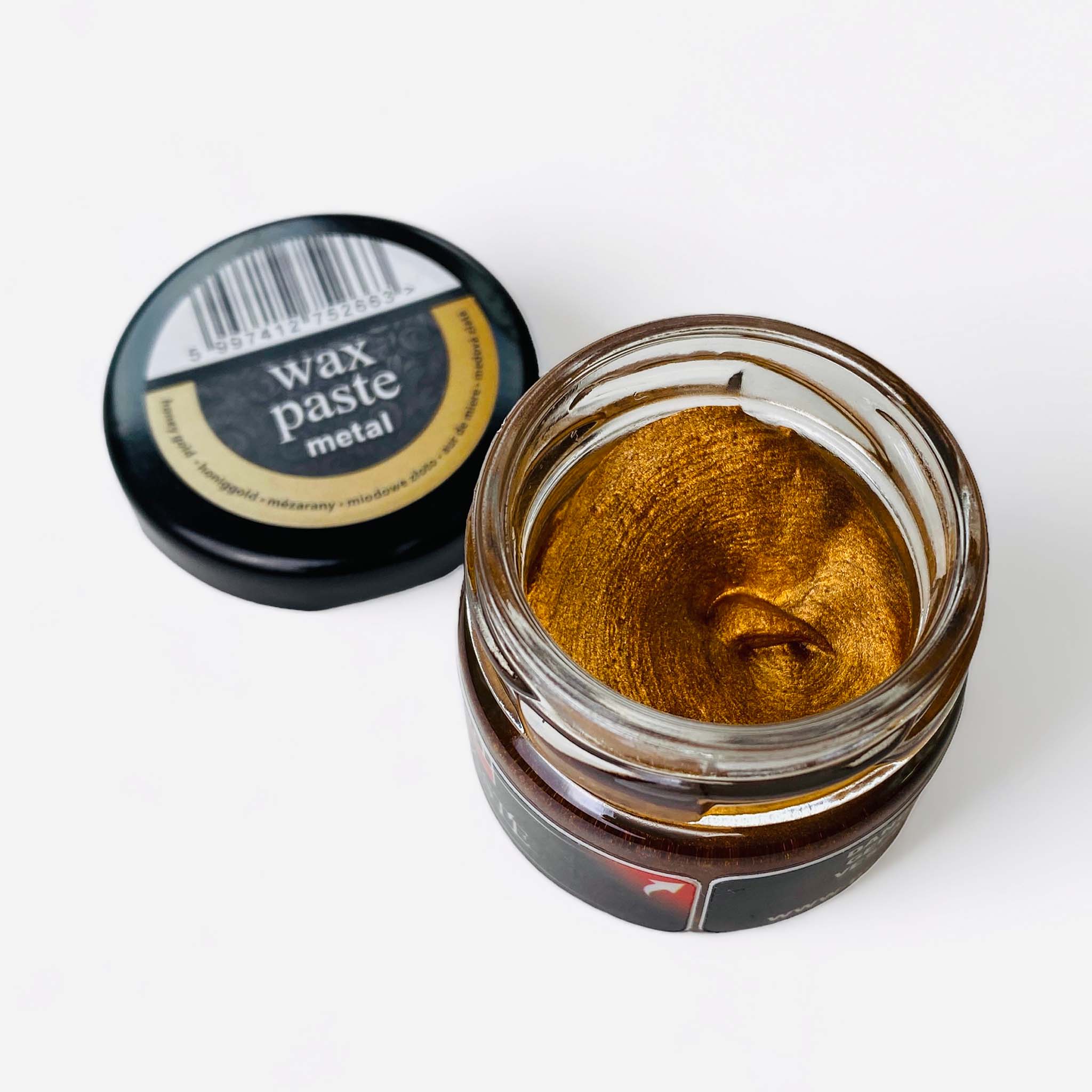 An open jar of a 20ml/0.68 ounce jar of metallic Honey Gold Wax Paste by Pentart is against a white background.