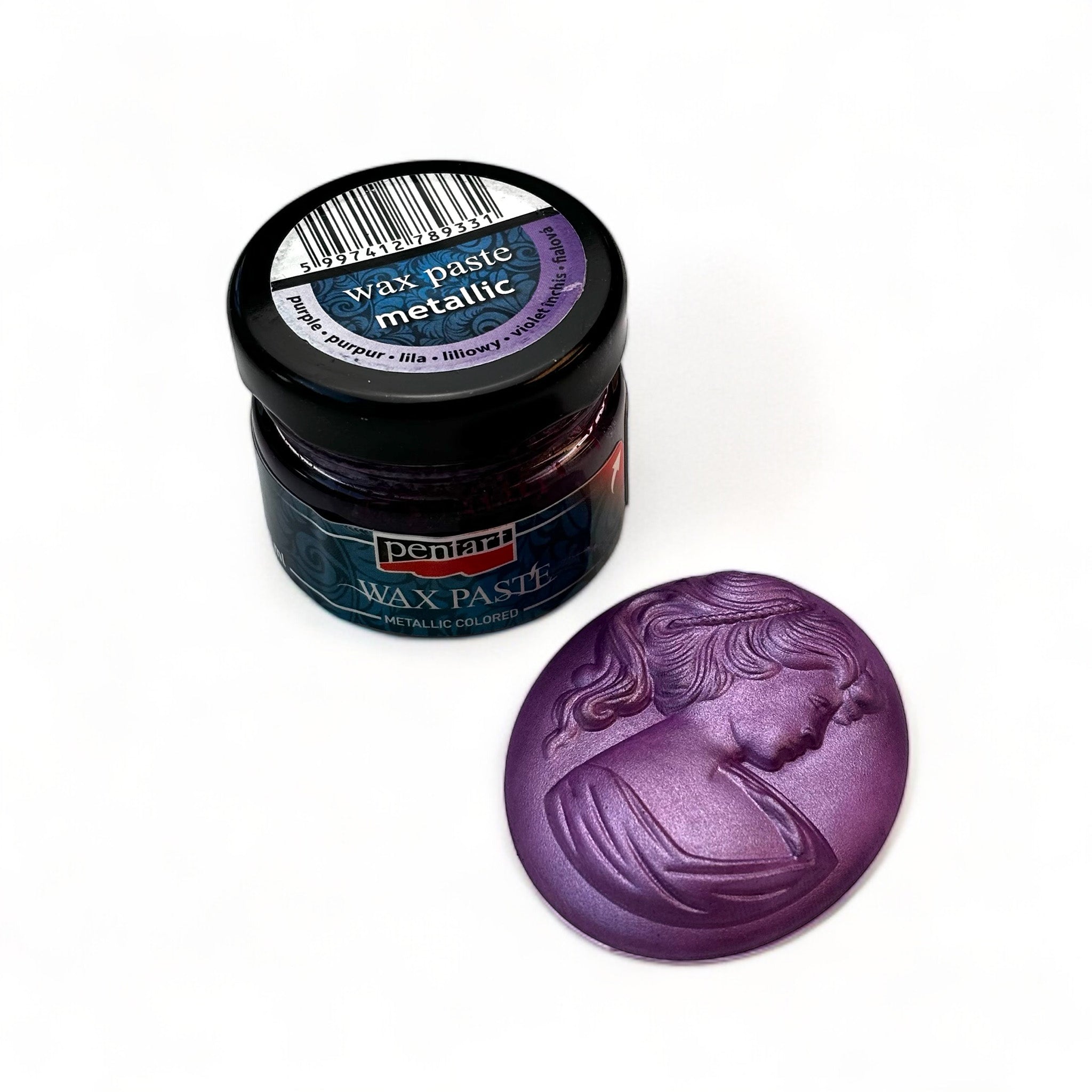 A jar of Pentart's Purple Metallic Wax Paste and a silicone mold casting of a cameo pendant finished in the wax are against a white background.