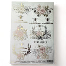 An A4 rice decoupage paper featuring floral designs, birdcages, and French writing highlighted with foil gilding is against a white background.