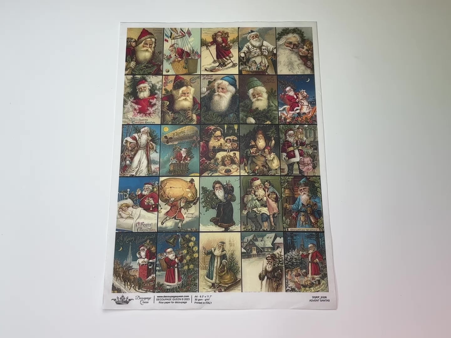 An 11 second video shows a close-up and backside of Decoupage Queen's Advent Santas rice paper against a white background.