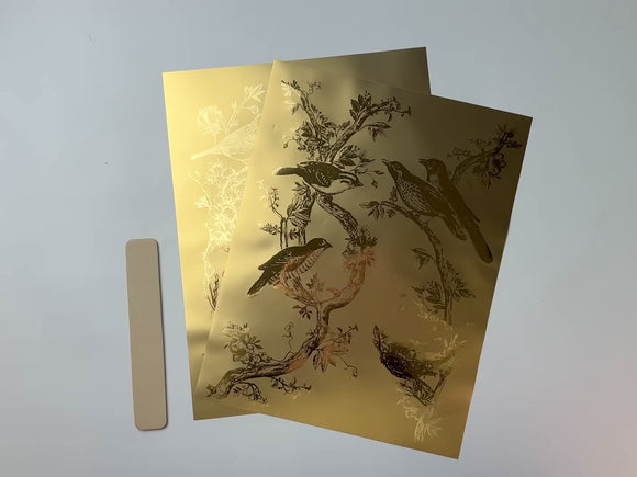 A 15 second video shows a close-up and backside of 2 sheets of ReDesign with Prima's Kacha Golden Serenade gold foil small rub-on transfers against a white background.