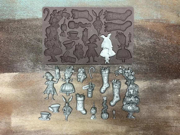 A 13 second video shows a close-up of Redesign with Primas Whimsical Holiday Dreams silicone mold and silver colored castings against a wood background. 