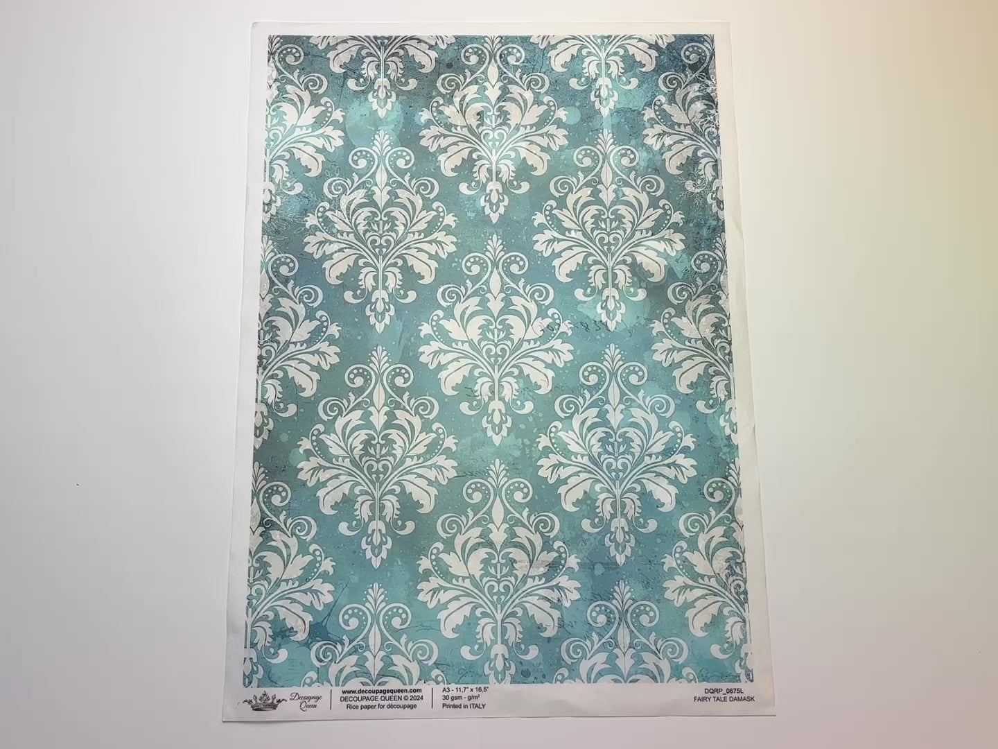 A 13 second video shows a close-up and backside of Decoupage Queen's Fairy Tale Damask A3 rice paper against a white background.