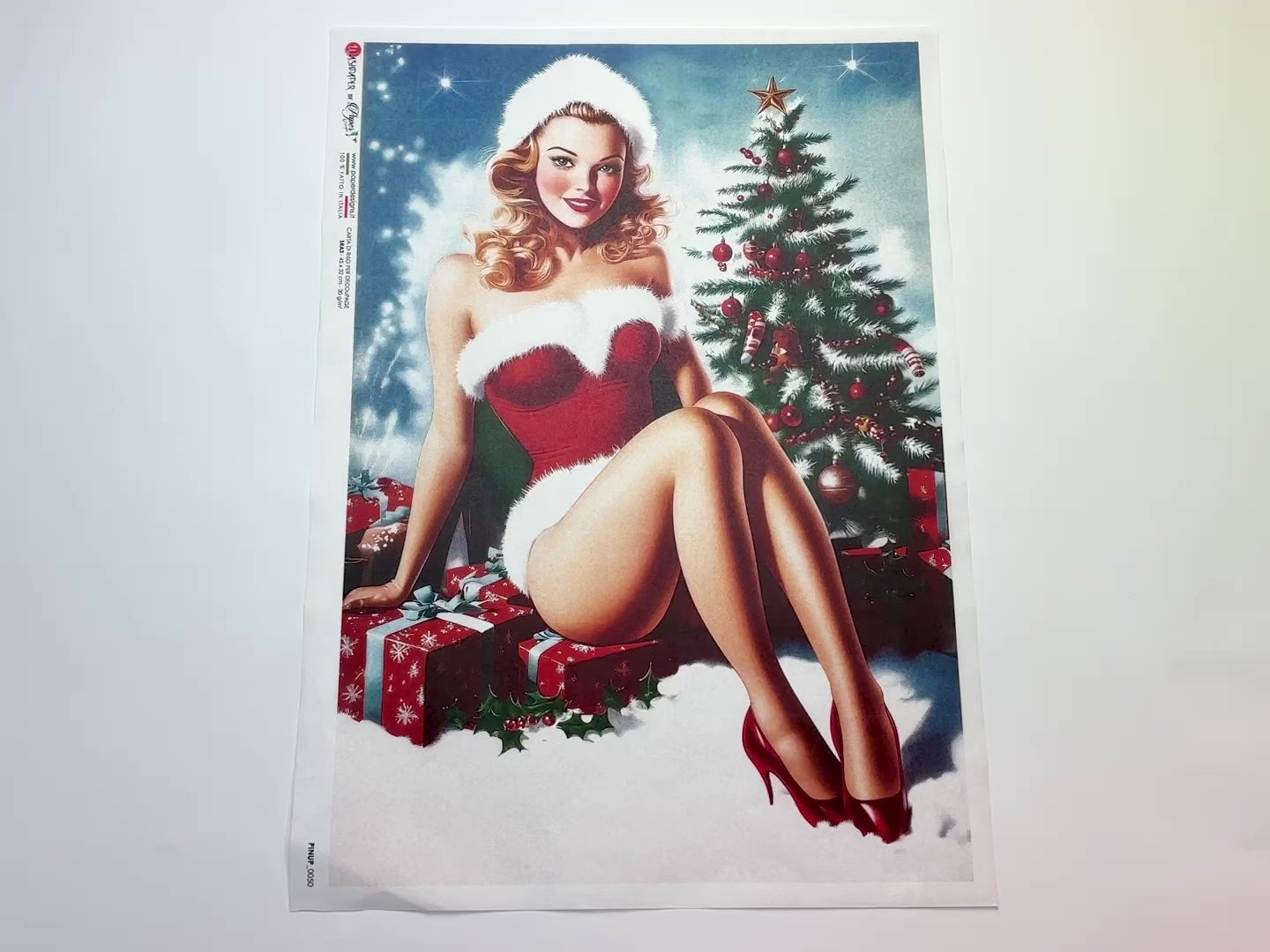 A 15 second video shows a close-up and backside of Paper Designs Italy's Festive Pinup Girl A3 rice paper against a white background.