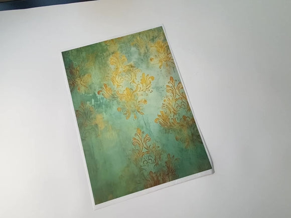 An 11 second video of a hand holding and lifting Decoupage Queen's Dreamscape Pattern A4 Plus rice sheet is against a white background.