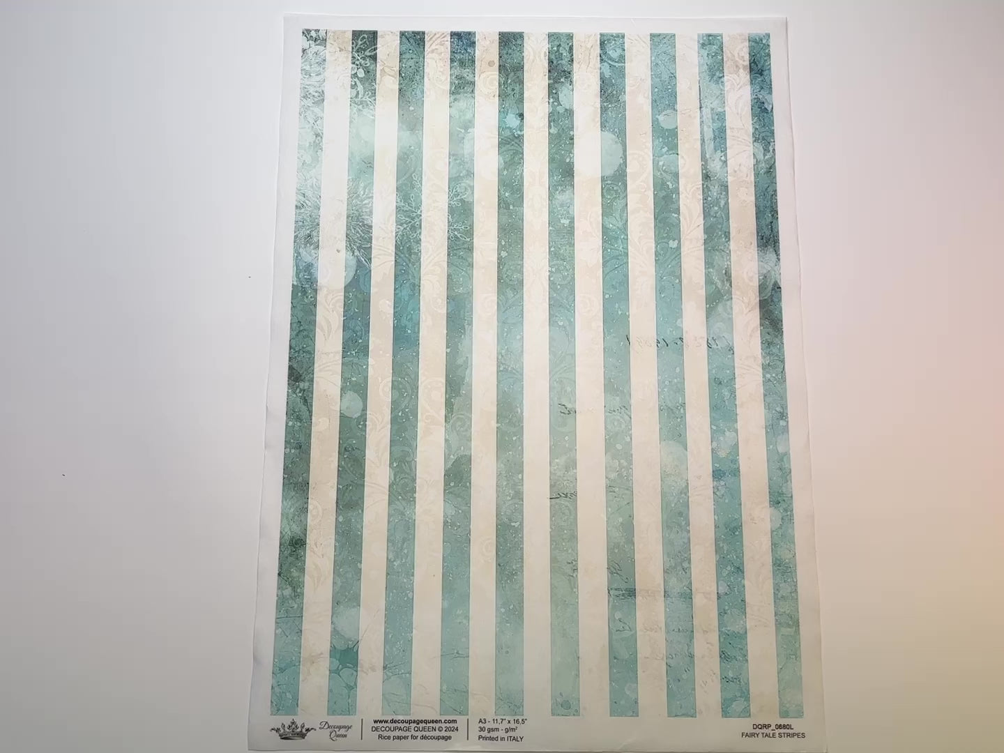 A 15 second video shows a close-up and backside of Decoupage Queen's Fairy Tale Stripes A3 rice paper against a white background.