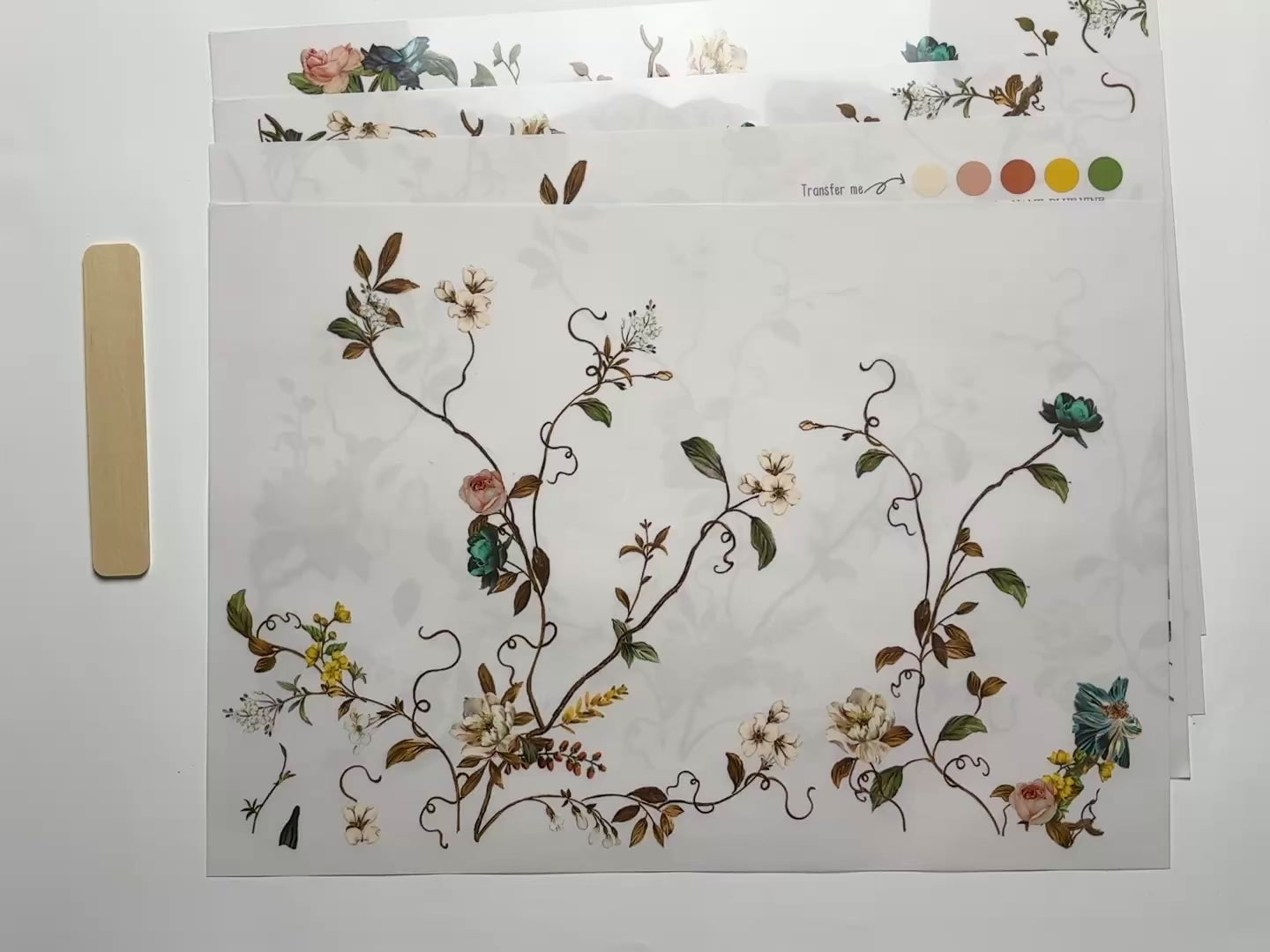 A 15 second video shows a close-up and backside of 4 sheets of ReDesign with Prima's Blue Vine rub-on furniture transfer against a white background.