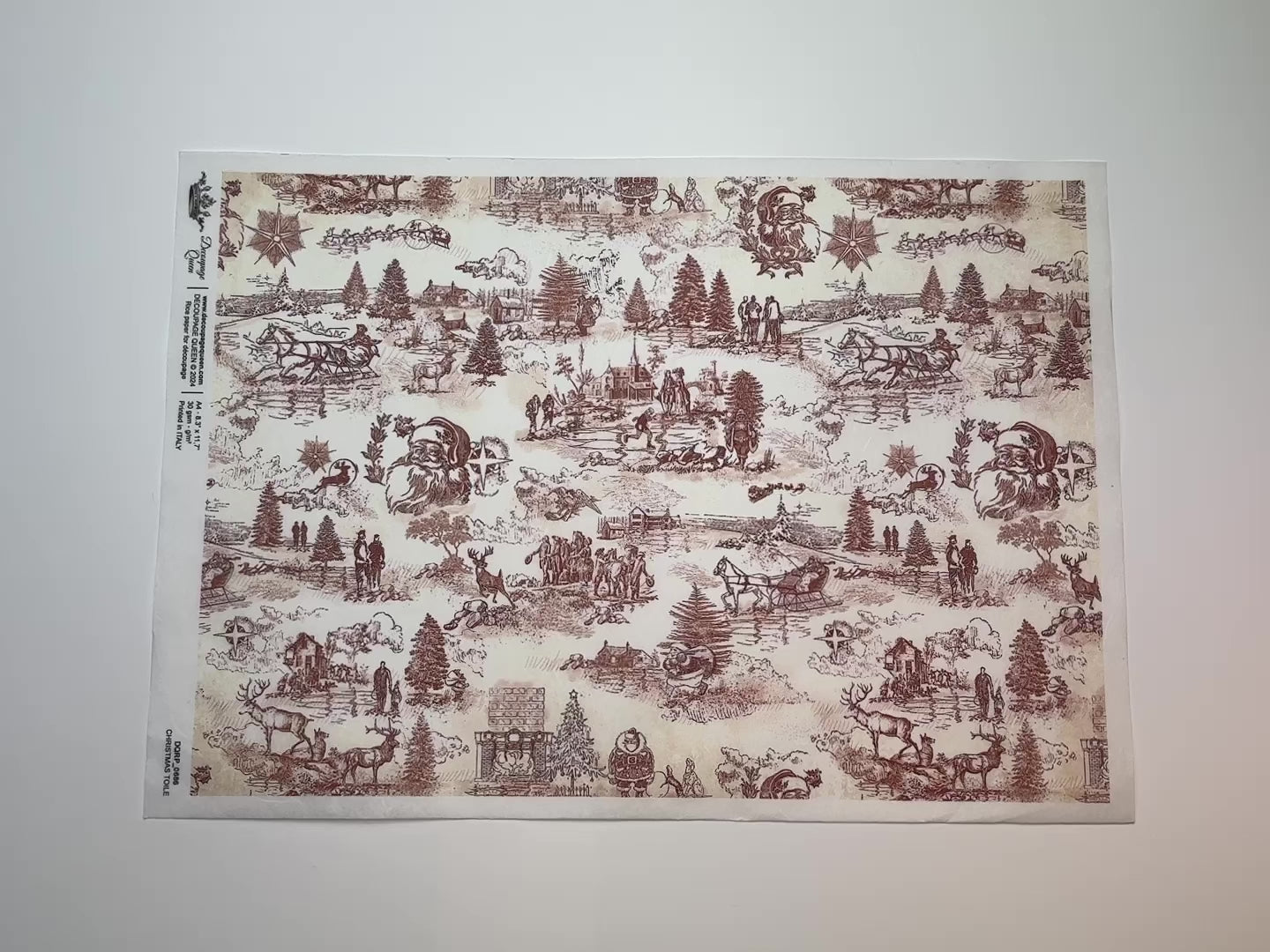 A 15 second video shows a close-up and backside of Decoupage Queen's Christmas Toile A4 rice paper against a white background.