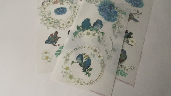 A 16 second video shows a close-up of 3 sheets of Get Inspired by Dadarkar Arts' Hydrangea Bliss small rub on transfers against a white background.