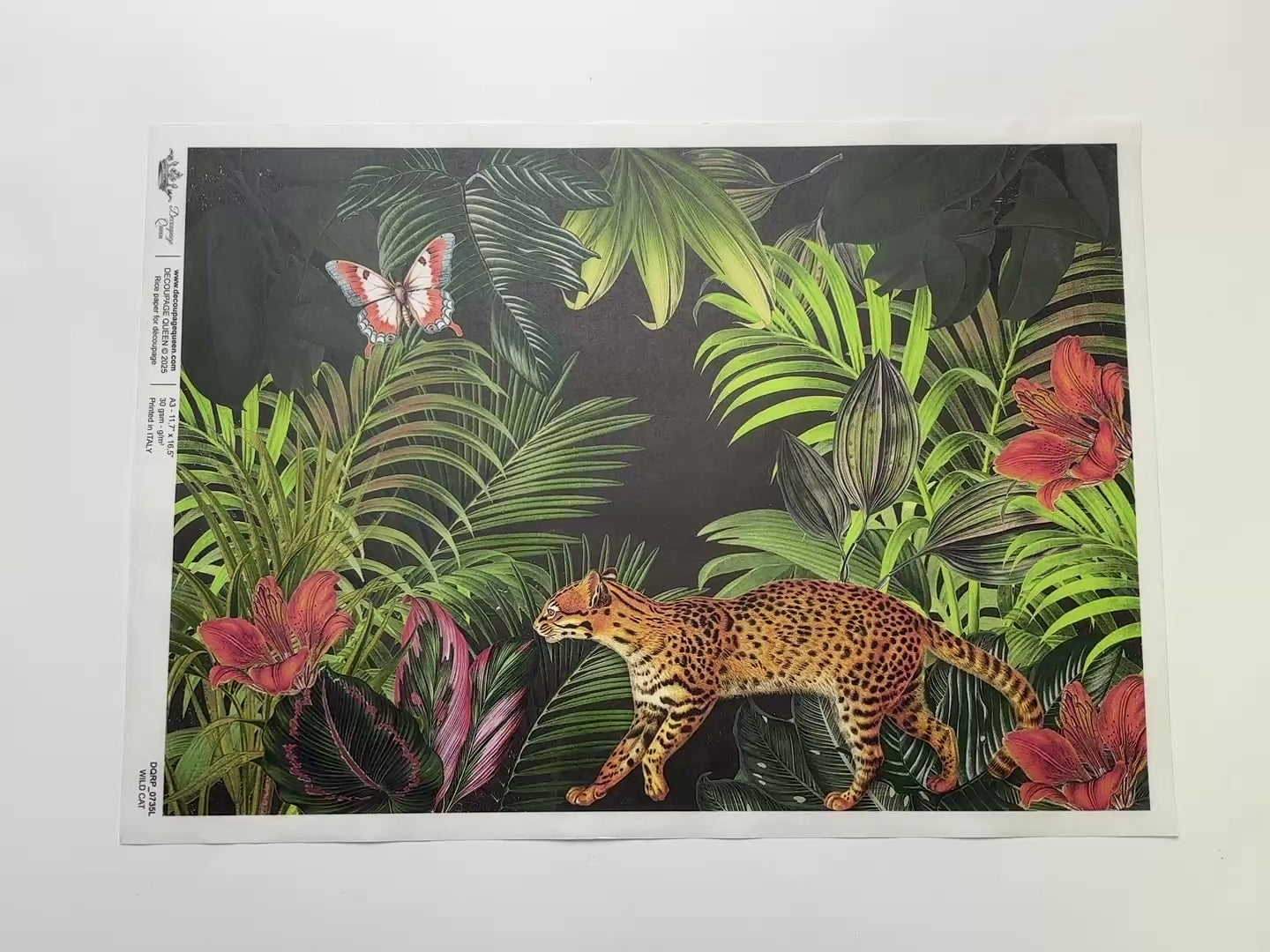 A 13 second video shows a close-up and backside of Decoupage Queen's Wild Cat A3 rice paper against a white background.