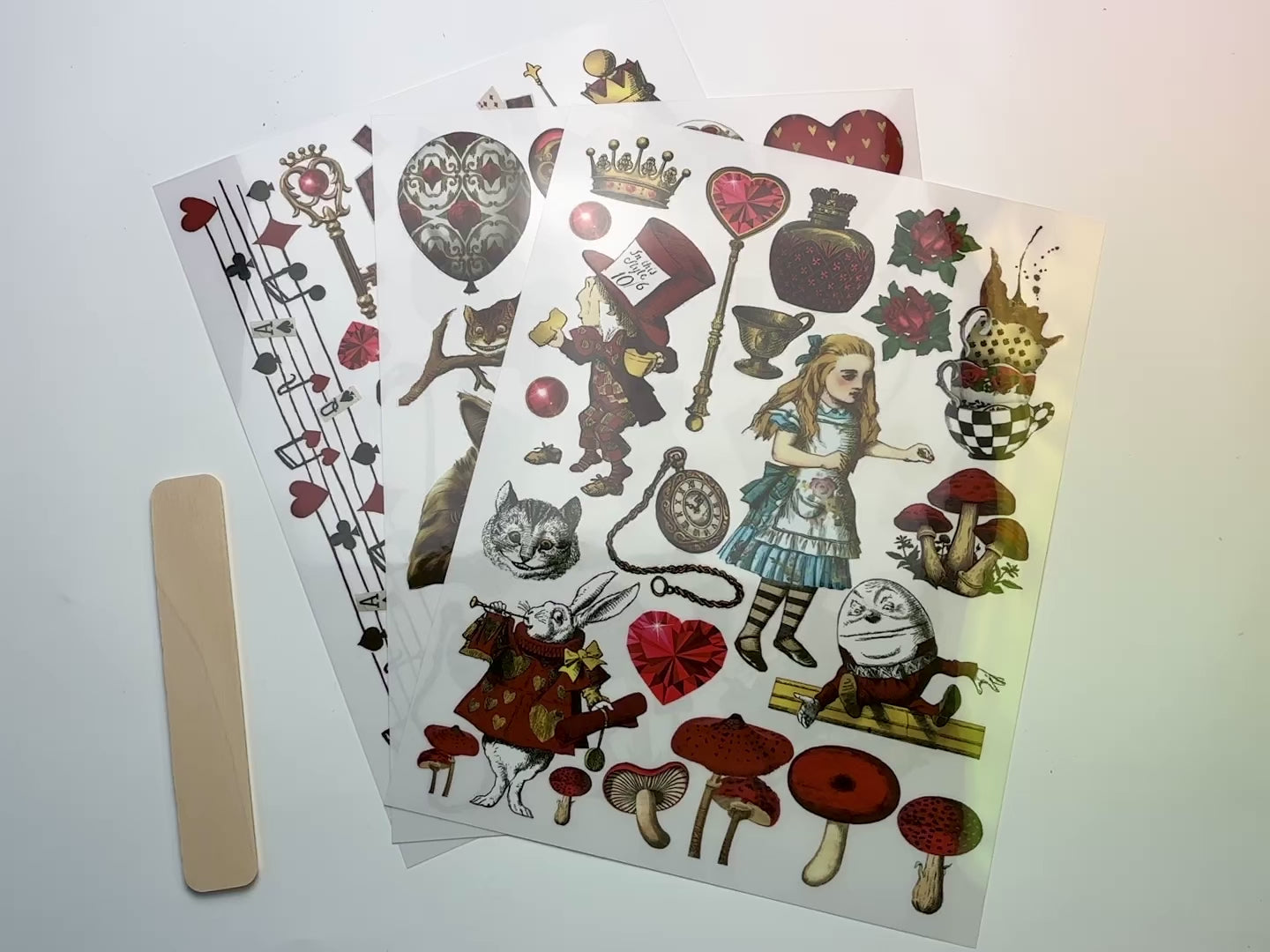 A 14 second video shows a close-up and backside of 3 sheets of ReDesign with Prima's Wonderland Impressions middy transfers.