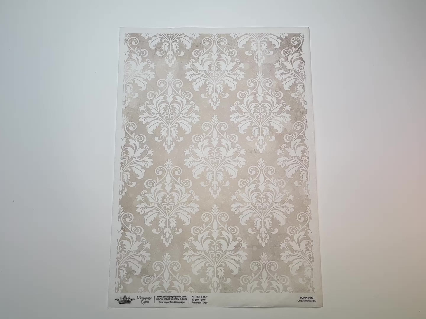 A 15 second video shows a close-up and backside of Decoupage Queen's Cream Damask A4 rice paper against a white background.