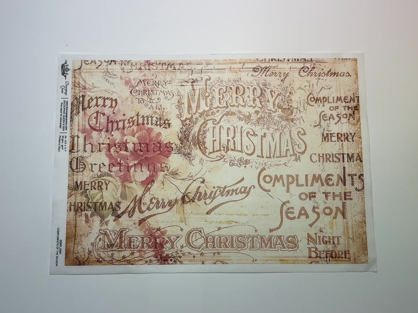 A 14 second video shows a close-up and backside of Decoupage Queen's Compliments of the Season A4 rice paper against a white background.