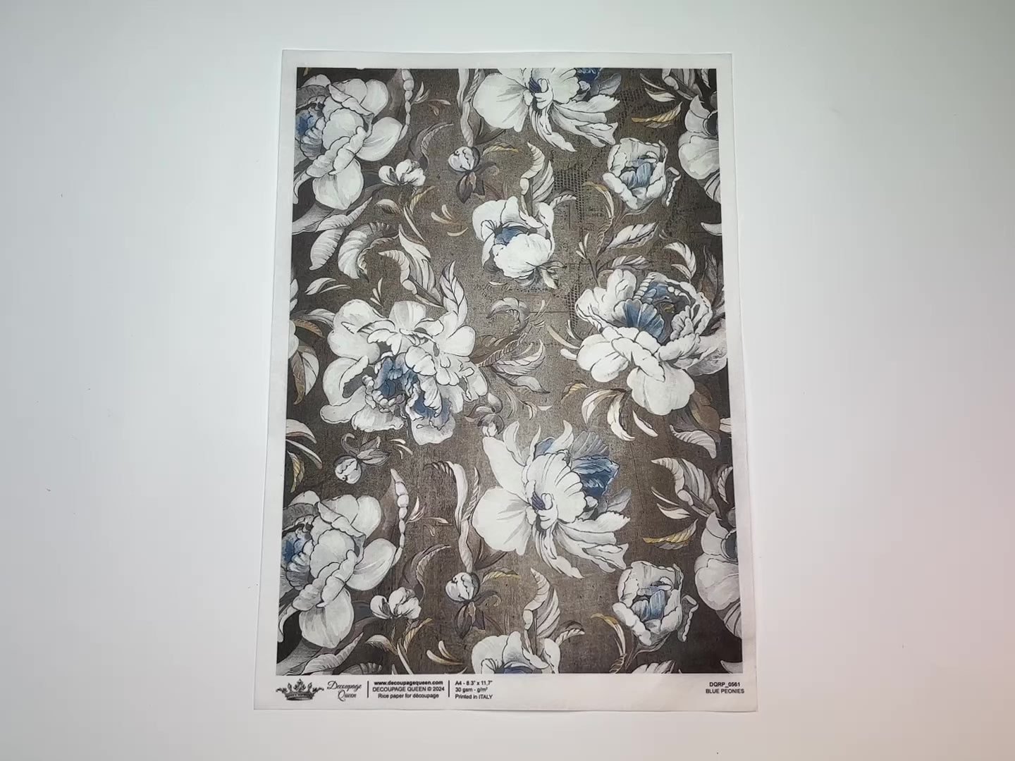 A 14 second video shows a close-up and backside of Decoupage Queen's Blue Peonies rice paper against a white background.