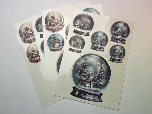 A 15 second video shows a close-up of 4 sheets of Belles & Whistles' Snow Globes hologram water slide transfer.