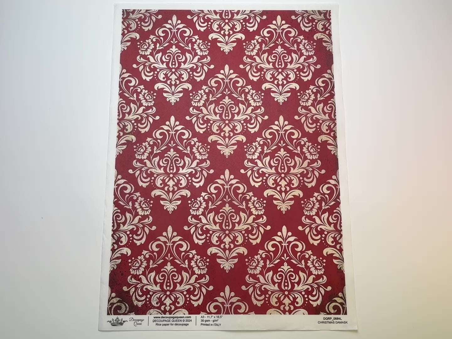 A 15 second video shows a close-up and backside of Decoupage Queen's Red Christmas Damask A3 rice paper against a white background.