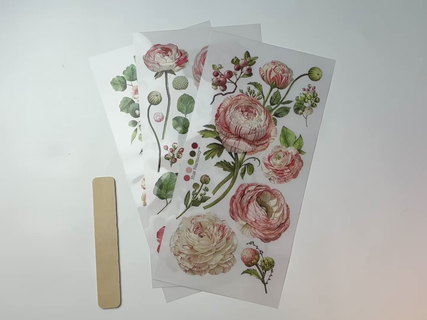 A 14 second video shows a close-up and backside of 3 sheets of ReDesign with Prima's Blushing Blooms small rub-on transfers against a white background.