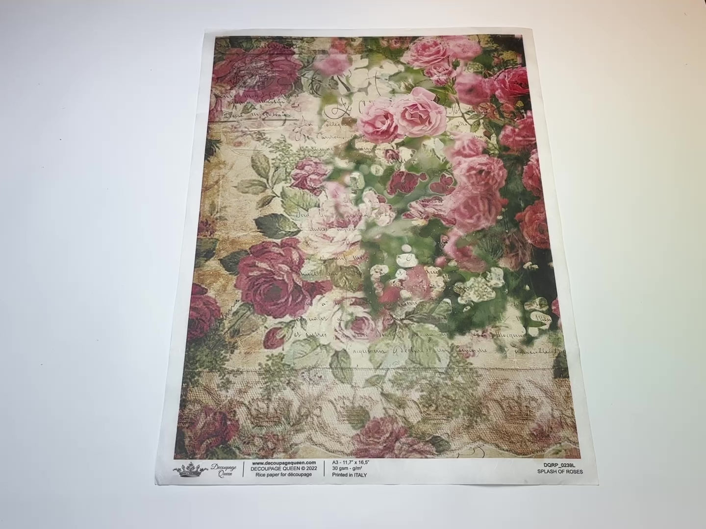 A 13 second video of a close-up and backside of Decoupage Queen's Splash of Roses A3 rice paper is against a white background.
