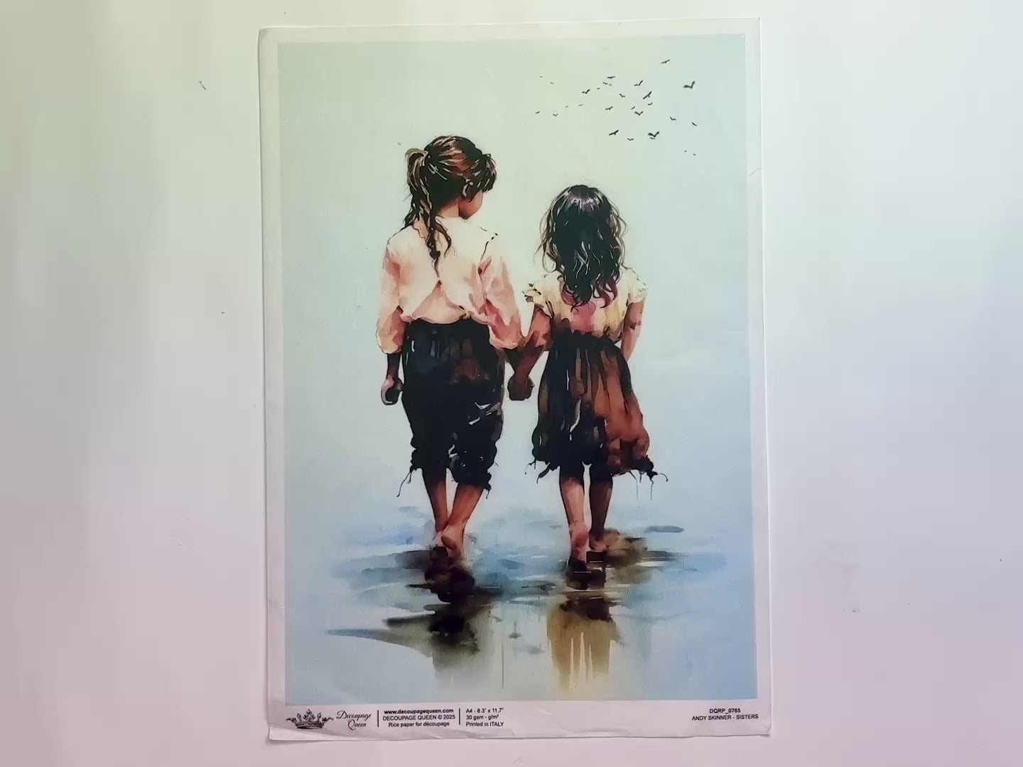 A 12 second video shows a close-up and backside of Decoupage Queen's Andy Skinner Sisters A4 rice paper against a white background.