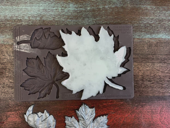 A 14 second video shows close-ups of ReDesign with Prima's Falling Leaves Fantasy silicone mold and silver colored castings. A hand is shown lifting and holding the mold and a casting.