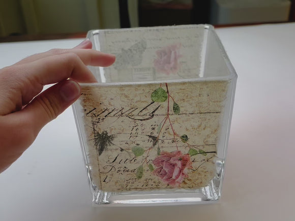 A 14 second video shows a square glass vase featuring Decoupage Queen's Pressed Flowers rice paper on it.