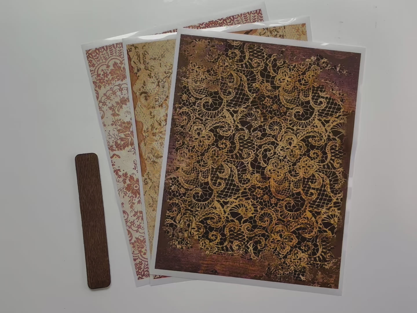 A 14 second video shows a close-up of 3 sheets of ReDesign with Prima's Delicate Lace middy transfer.