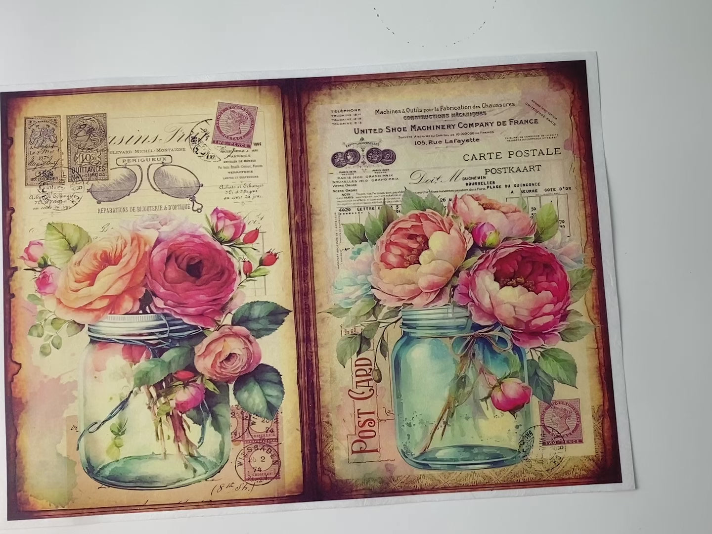 A 14 second video shows a close-up and hand lifting and folding over the top left corner of Decoupage Queen's Flowers in Mason Jar 5 against a white background.