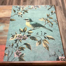 A 10 second video shows a close-up of ReDesign with Prima's Blue Song A1 fiber paper against a wood background.