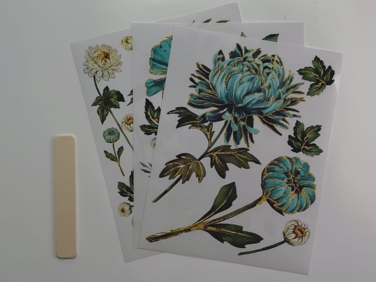 A 13 second video shows a close-up of 3 sheets of ReDesign with Prima's Gilded Floral middy transfer.