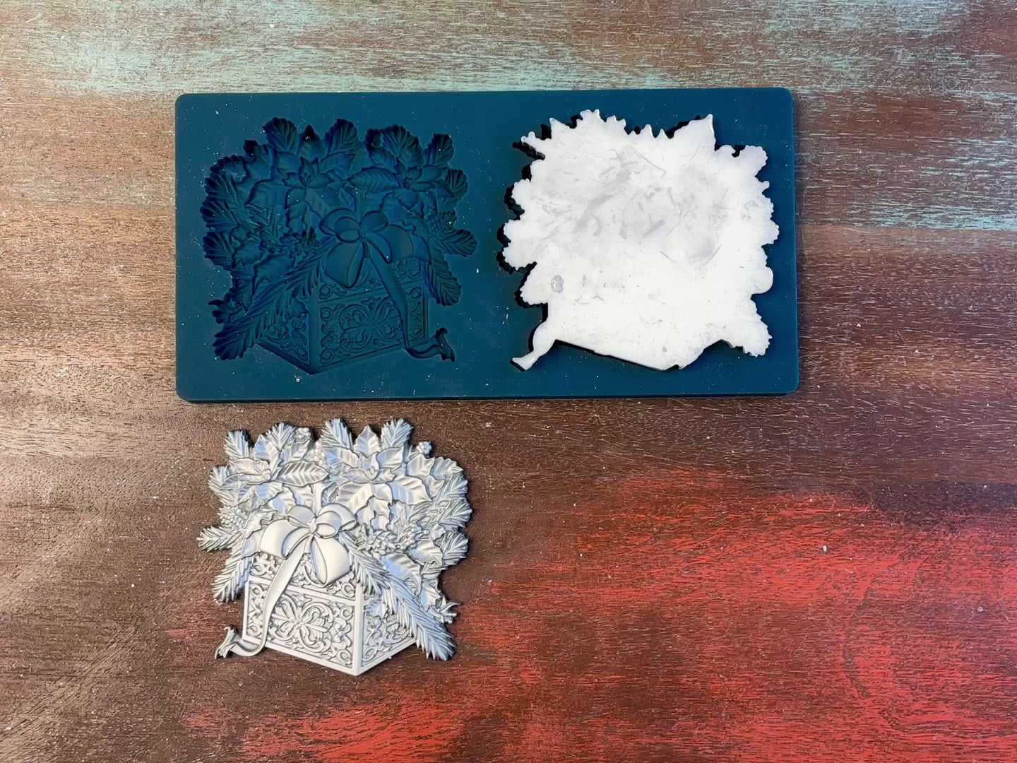 A 13 second video of Zuri Design's Christmas Gifts Set 1 is against a wood background. A hand is shown holding one of the castings.