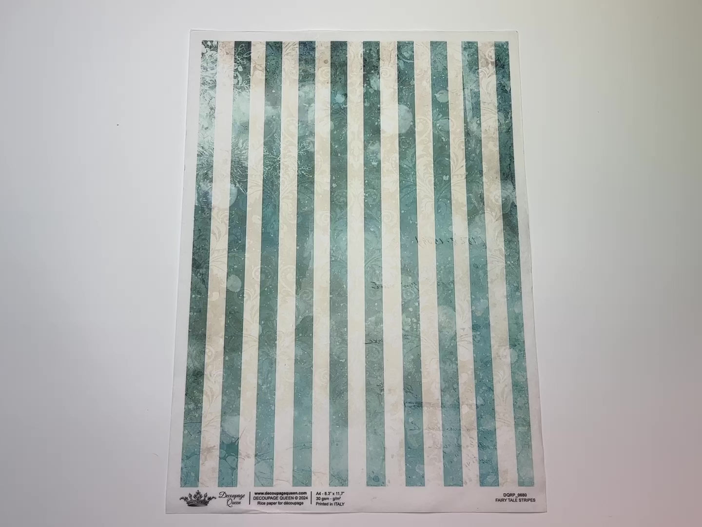 A 14 second video shows a close-up and backside of Decoupage Queen's Fairy Tale Stripes A4 rice paper against a white background.