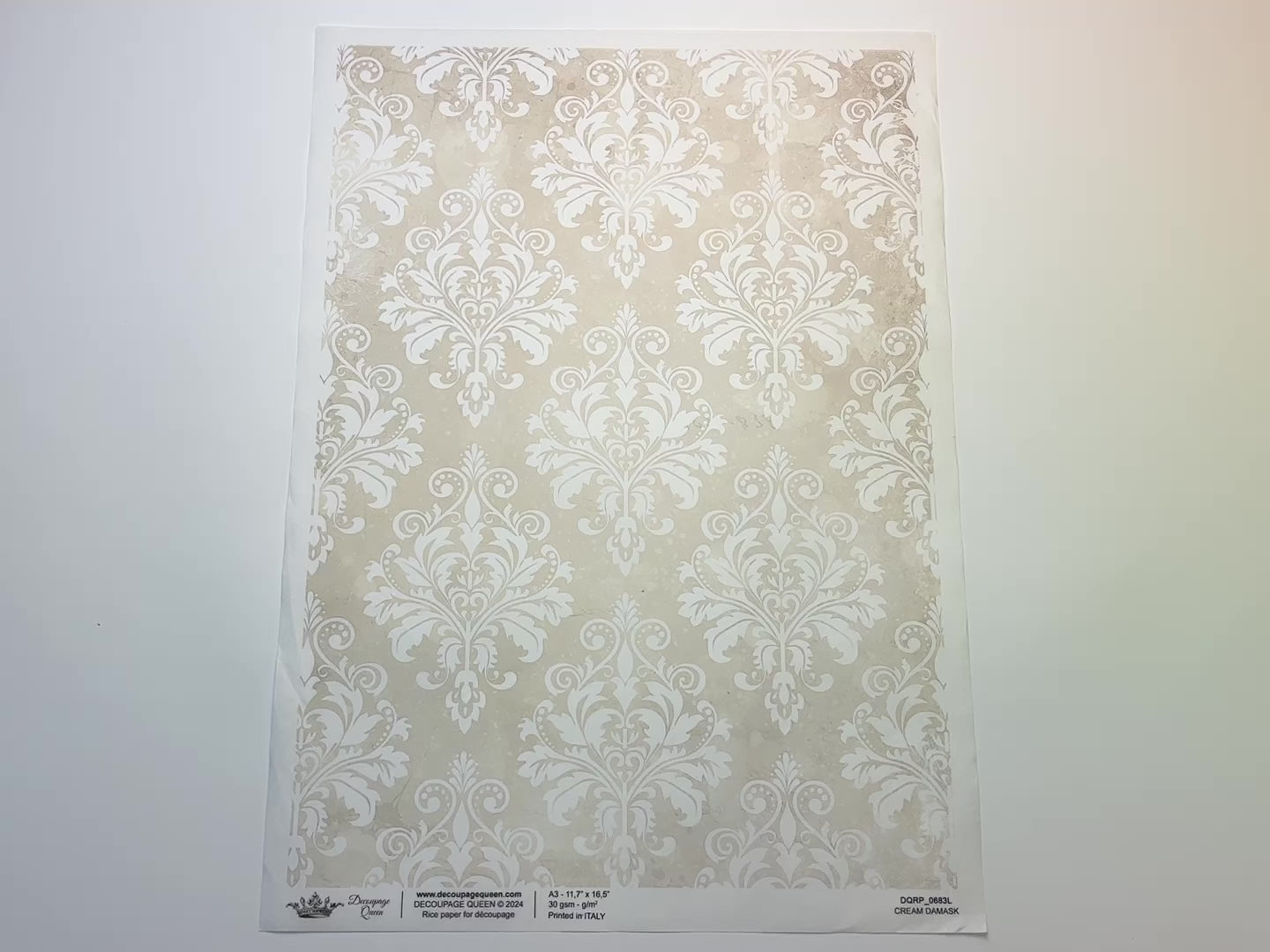 A 15 second video shows a close-up and backside of Decoupage Queen's Cream Damask A3 rice paper against a white background.