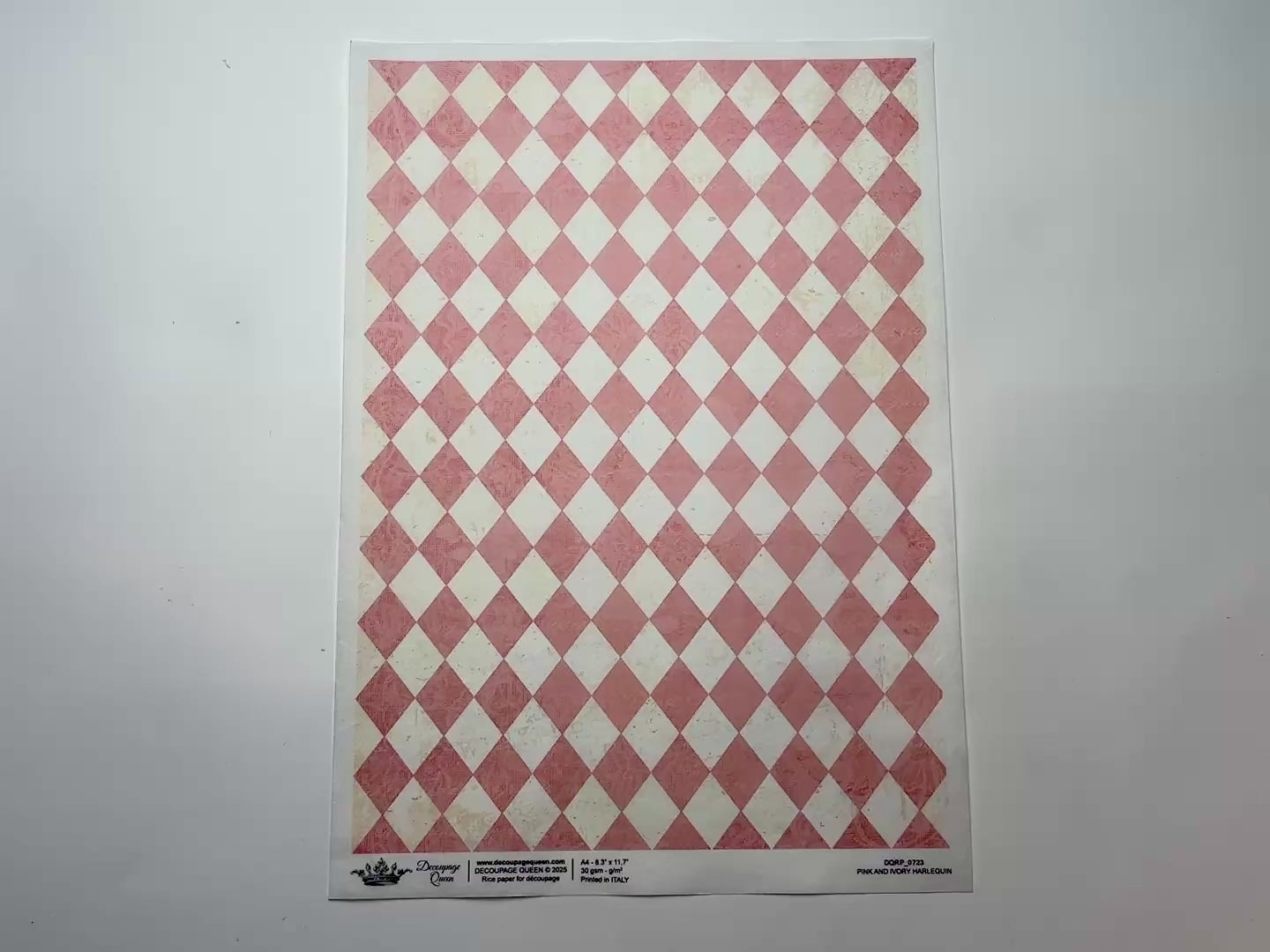 A 14 second video shows a close-up and backside of Decoupage Queen's Pink and Ivory Harlequin A4 rice paper against a white background.