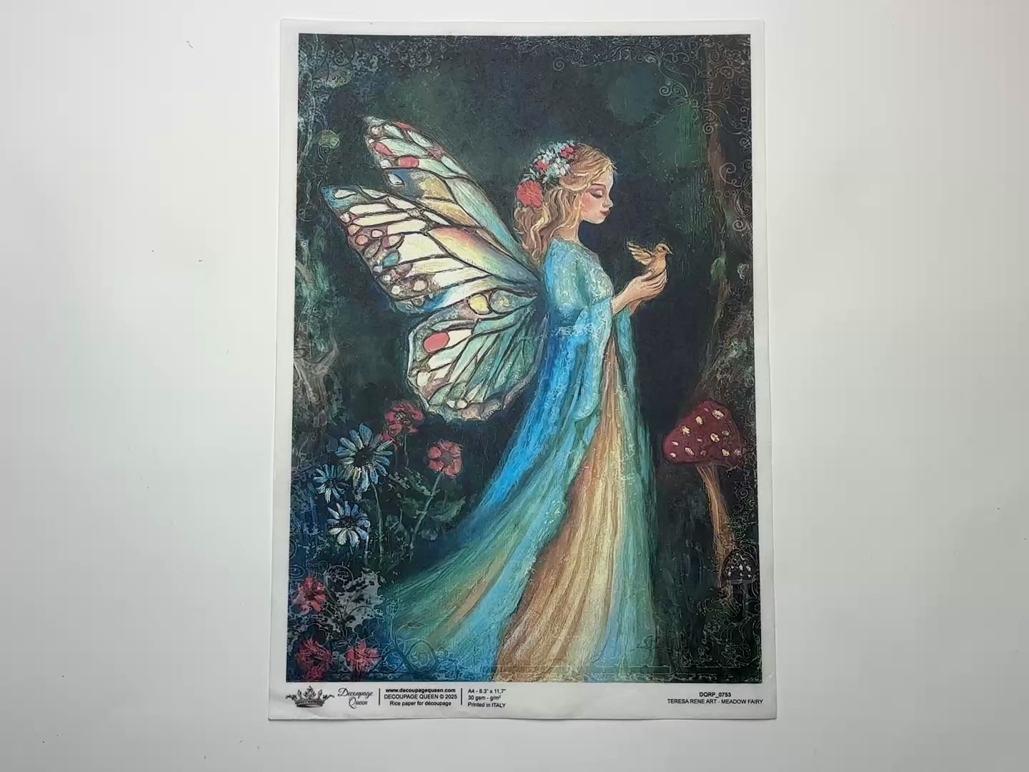 A 14 second video shows a close-up and backside of Decoupage Queen's Meadow Fairy A4 rice paper against a white background.