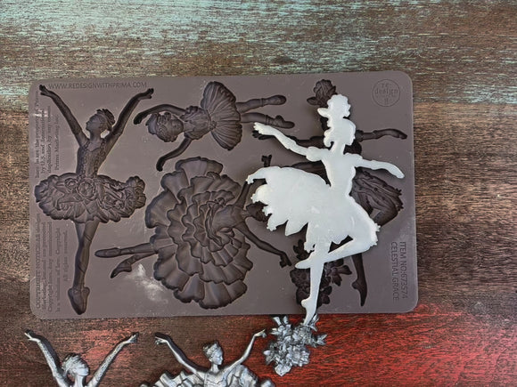 A 14 second video shows close-ups of ReDesign with Prima's Celestial Grace silicone mold and silver colored castings. A hand is shown lifting and holding the mold and a casting.