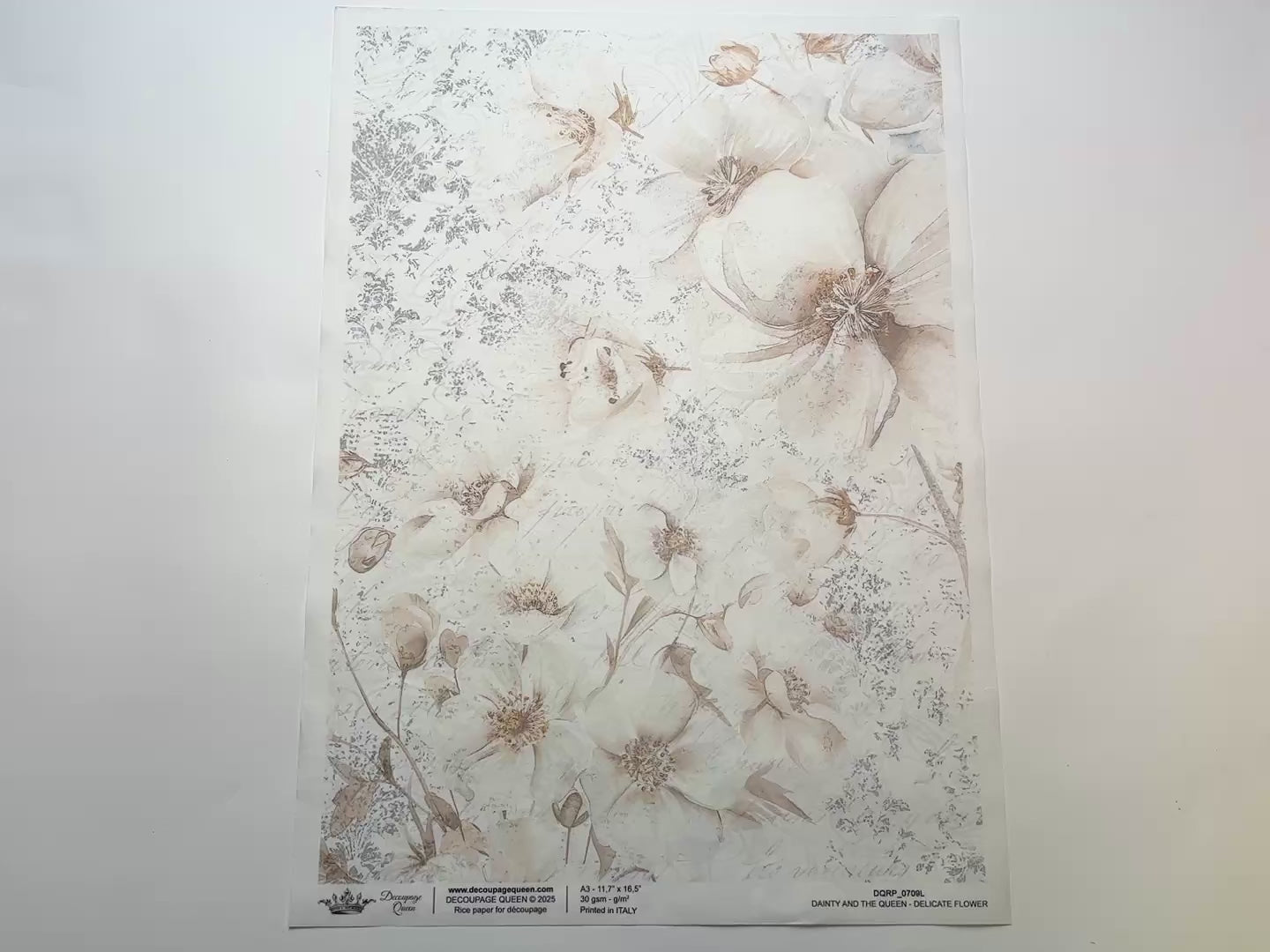 A 14 second video shows a close-up and backside of Decoupage Queen's Delicate Flower A3 rice paper against a white background.