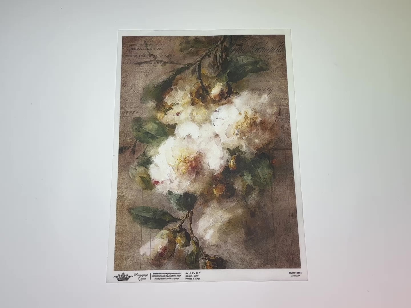 An 11 second video shows a close-up and backside of Decoupage Queen's Camelia rice paper against a white background.