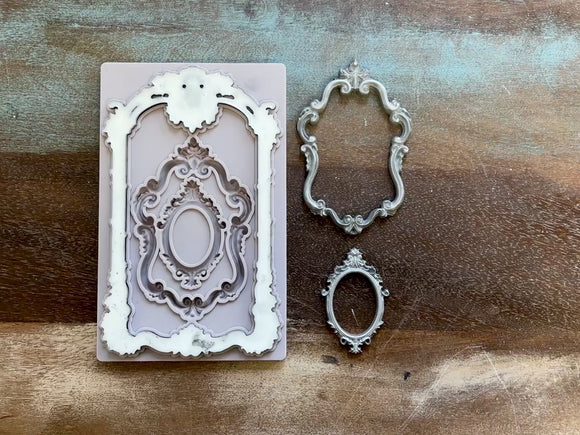 A 14 second video shows a close-up of Decoupage Queen's Antique Frames silicone mold and silver colored castings against a wood background. A hand is shown picking up the largest casting off of the mold.