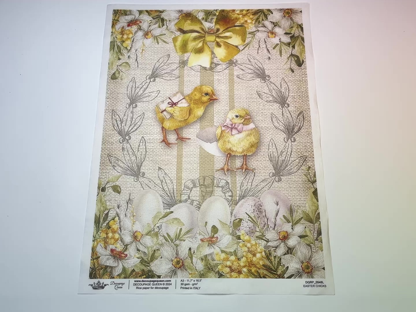 A 13 second video of a close-up and backside of Decoupage Queen's Easter Chicks A3 rice paper is against a white background.