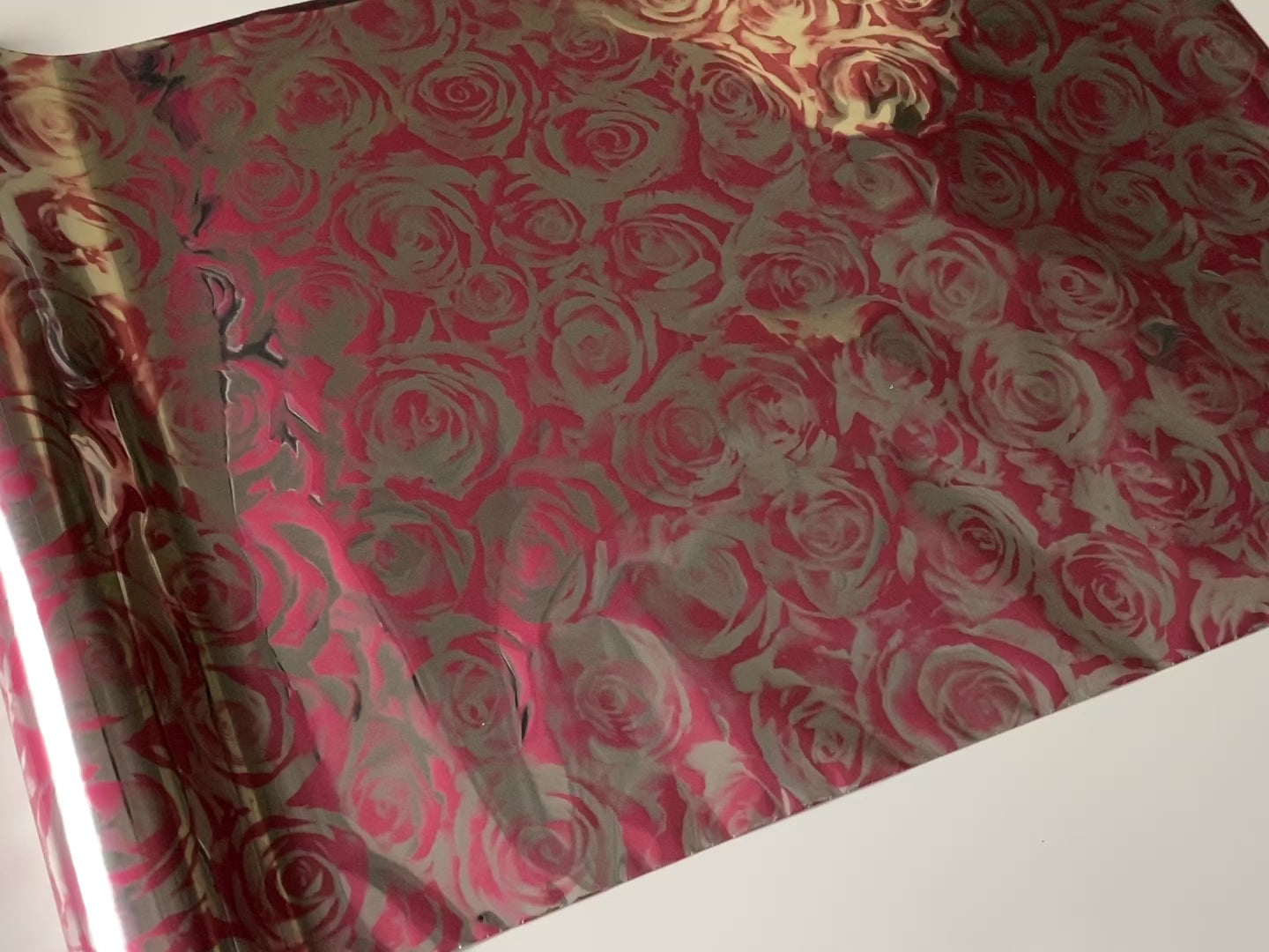 A 12 second video that shows a close-up of a roll of Artistic Painting Studio's Roses Pink Metallic Transfer Foil against a white background.