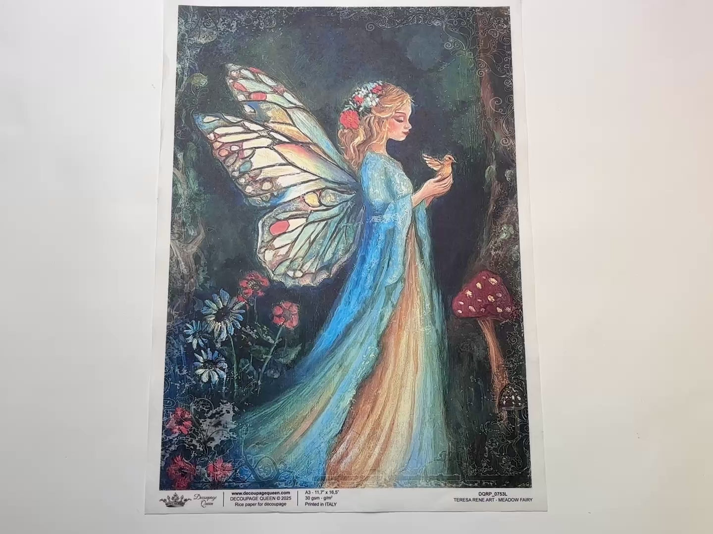 A 15 second video shows a close-up and backside of Decoupage Queen's Meadow Fairy A3 rice paper against a white background.