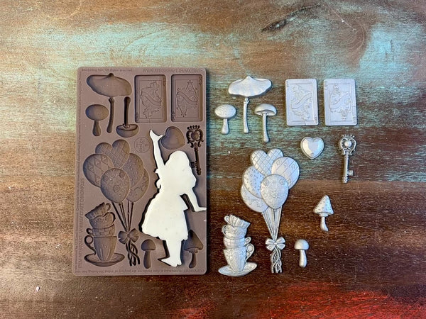 A 13 second video shows a close-up ReDesign with Prima's Whimsy Craft Chronicles silicone mold and silver colored castings. A hand is shown holding one of the castings.