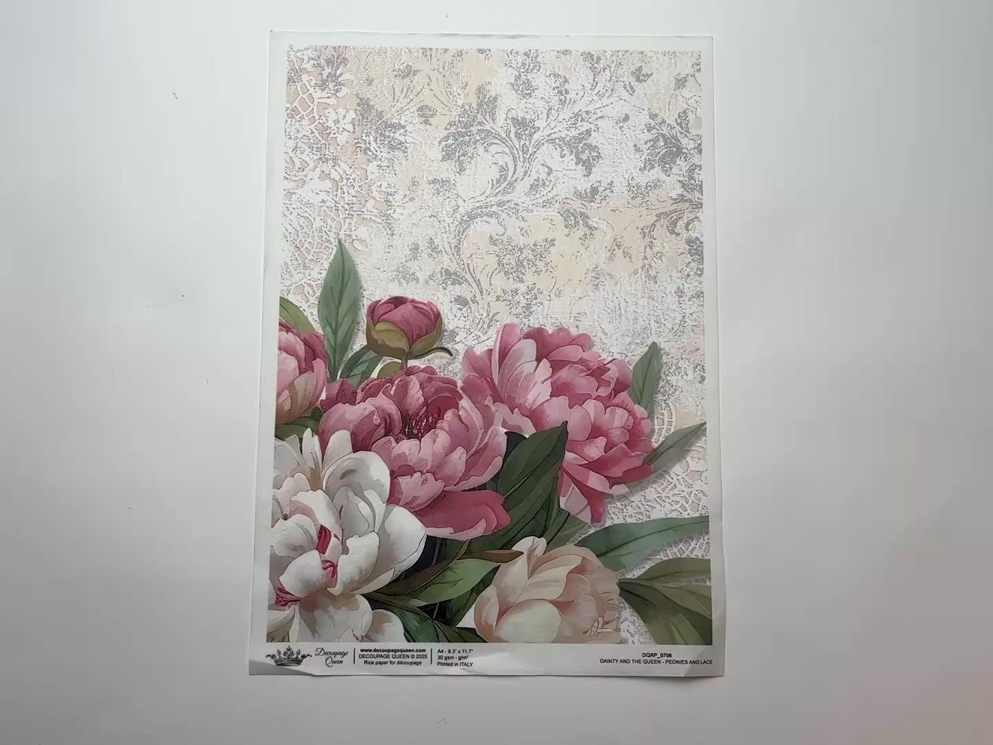 A 14 second video shows a close-up and backside of Decoupage Queen's Peonies and Lace A4 rice paper against a white background.