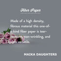 A gray background with a bouquet of roses. White text is shown reading: Fiber paper. Made of a high density, fibrous material this one-of-a-kind fiber paper is tear-resistant, non-wrinkling, and ultra versatile. Maikadaughters.com