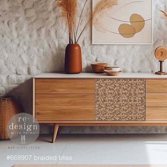 A mid-century TV consol or dresser is painted partially white with natural wood and features ReDesign with Prima's Braided Bliss A1 fiber paper on the front center between its drawers.