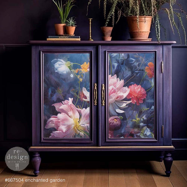 A vintage small buffet table is painted deep blue and features ReDesign with Prima's Enchanted Garden A1 fiber paper on its 2 doors.