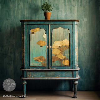 A vintage small armoire is painted deep teal and features ReDesign with Prima's Eternal Lotus A1 fiber paper on its 2 doors.